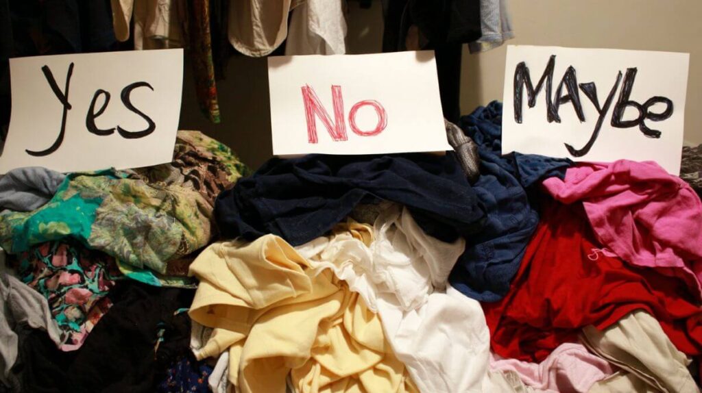 The One-Year Rule: What I Learned From Purging My Closet 3 Organised wardrobe piles labelled for a closet clean-out using the One-Year Rule
